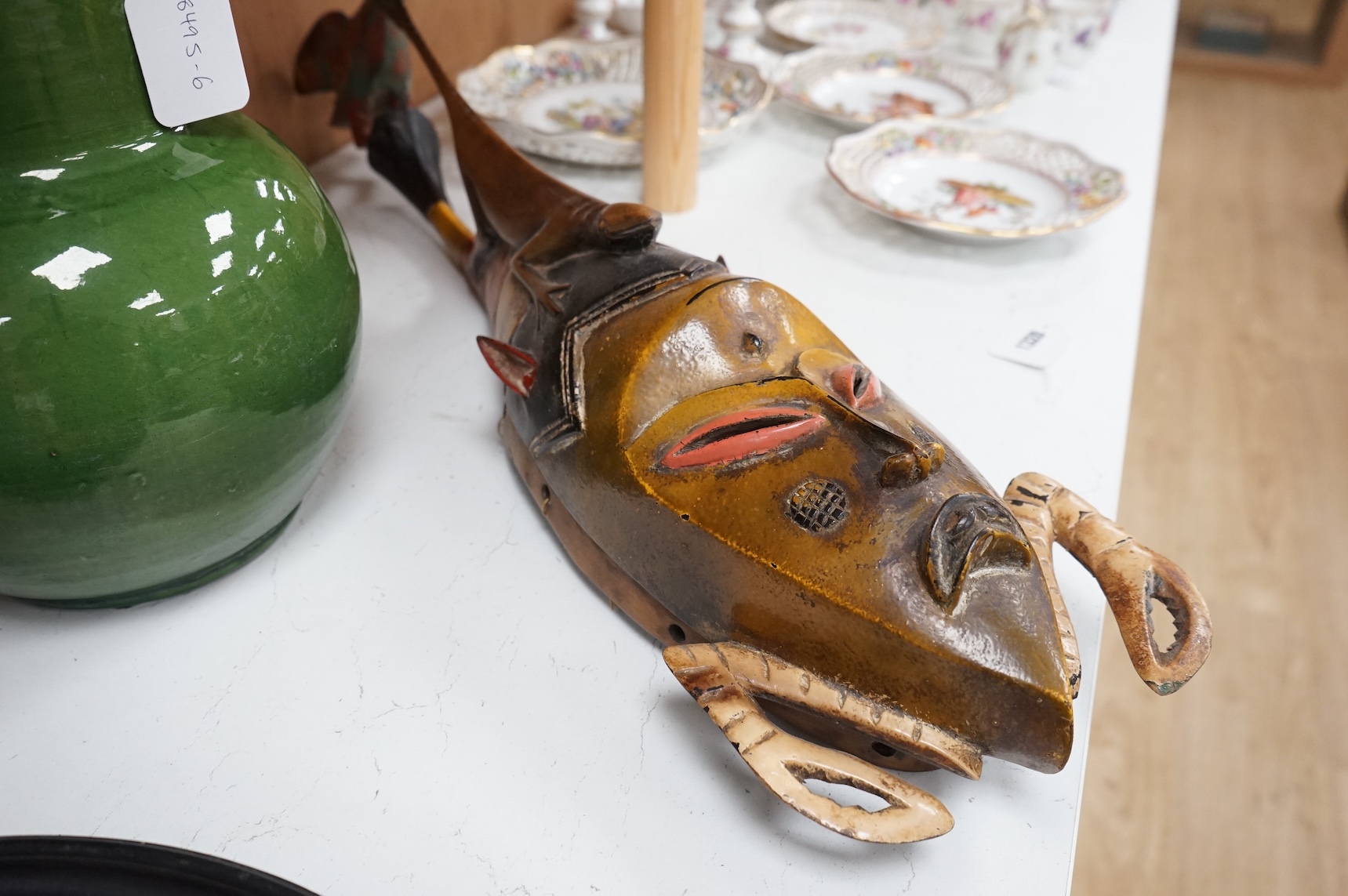 An early 20th century Tribal carved and painted mask from the Ivory Coast, 74cm in length
